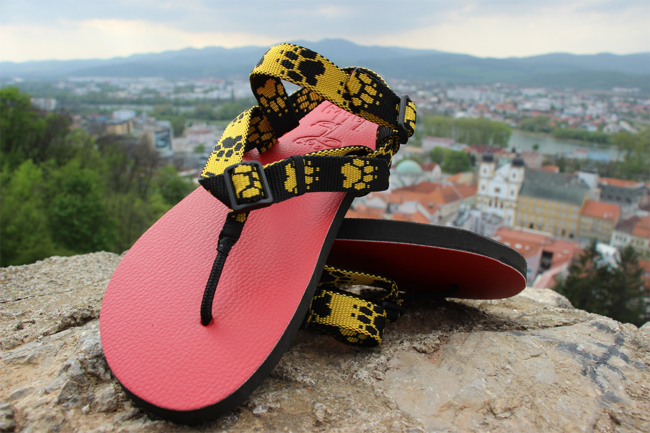 Slovenské ručne vyrobené barefoot sandále na Trenčianskom hrade, červená podrážka, popruhy so žltými stopami